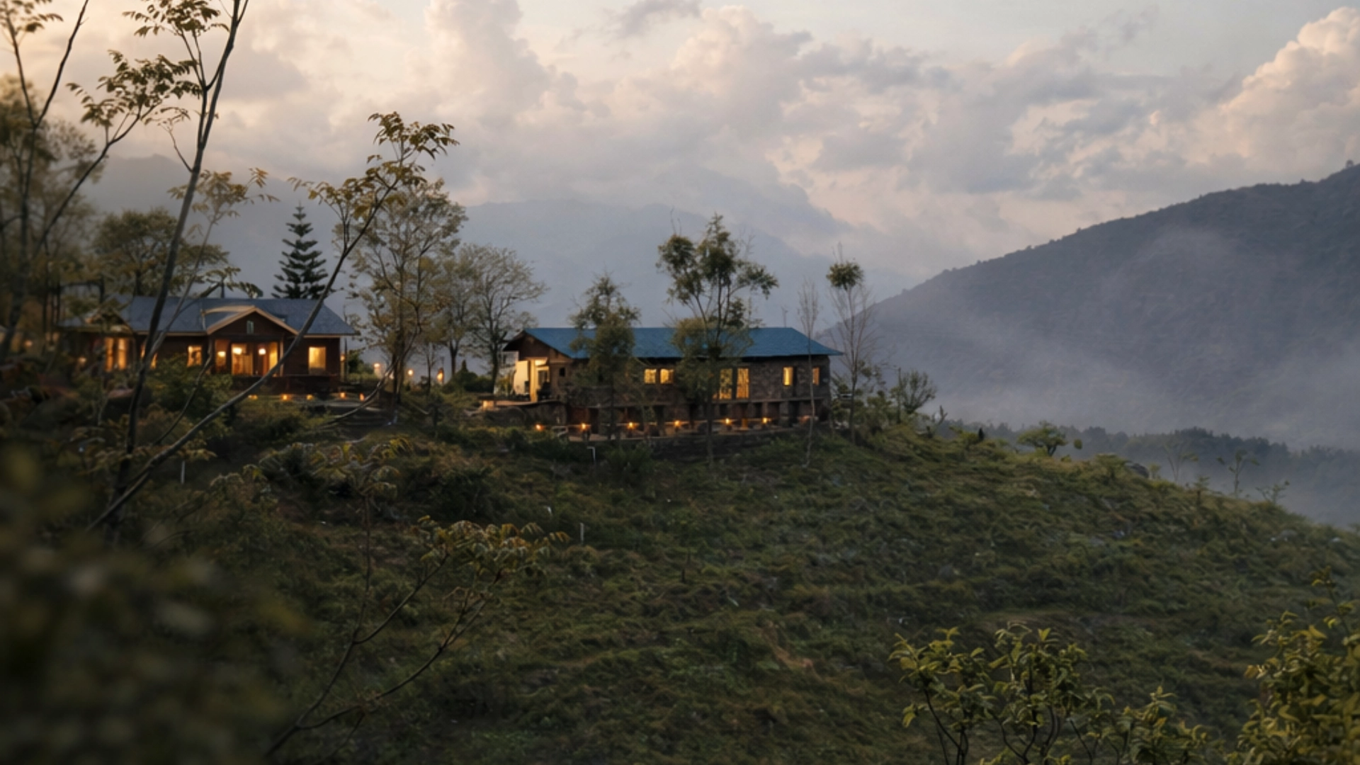 Cottages of Raht Juneo Orchards on a forested ridge at dusk in Rajgarh, Himachal Pradesh